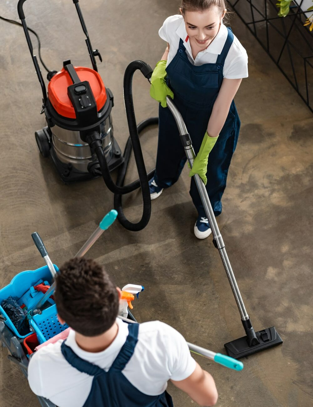 high angle view of smiling cleaner vacuuming floor 2024 11 14 13 49 06 utc min 1000x1300 1 1